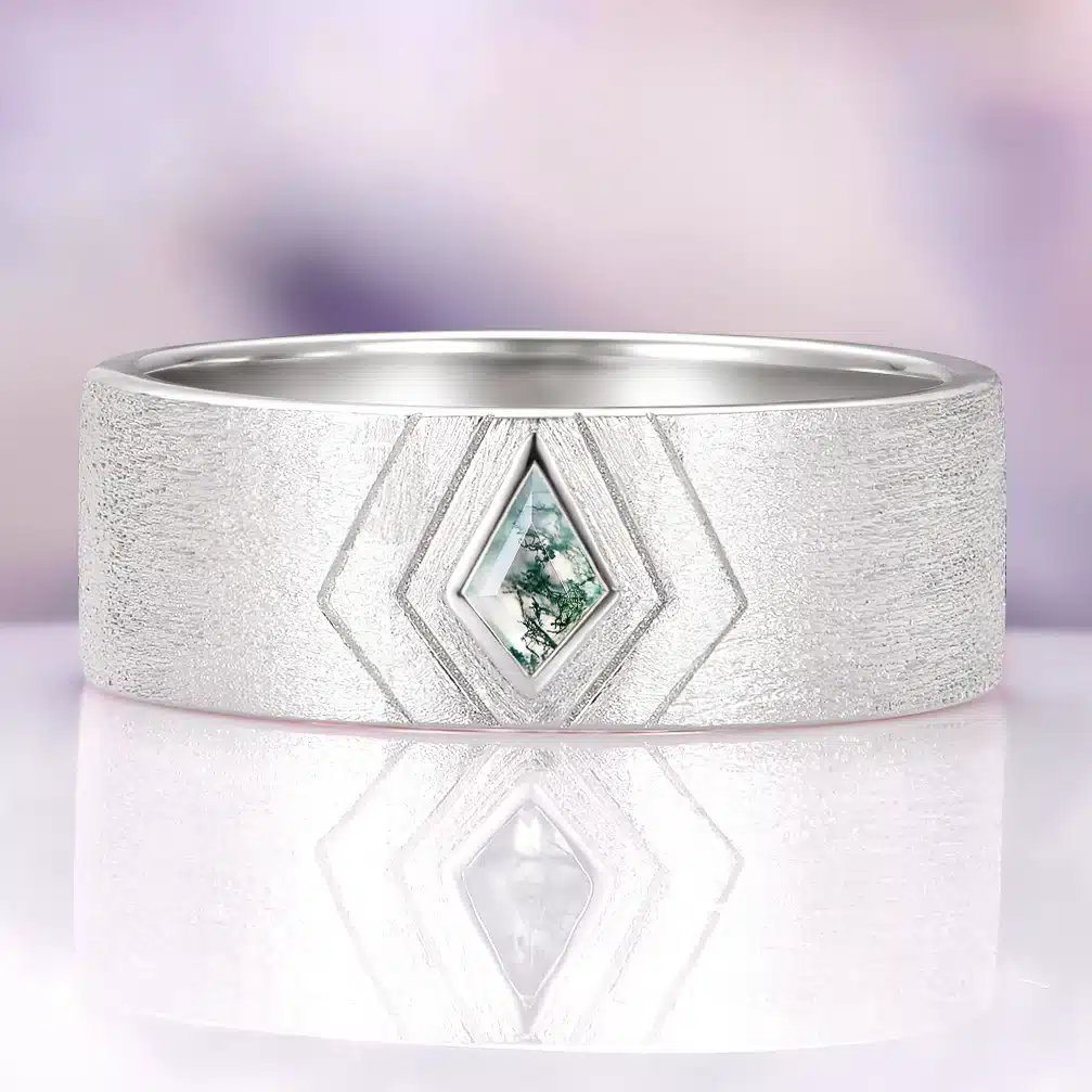 Wide silver wedding band with a kite cut moss agate stone and natural green mineral inclusions