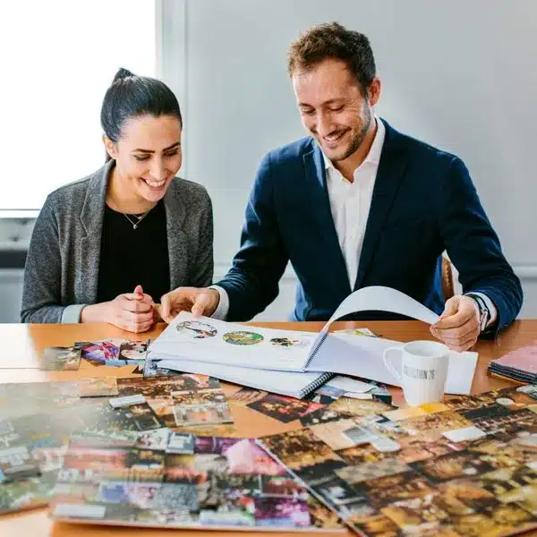 Joe Blackman reviewing an event design lookbook and photo moodboard with a colleague